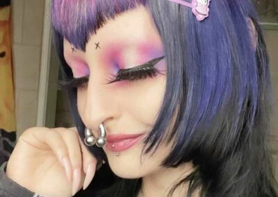 Person with multi-colored hair, black, blue, pink, and purple.